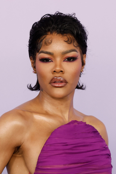 Teyana Taylor posing in a purple strapless gown